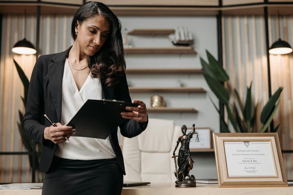 Law firm office with solicitor working at desk reviewing documents