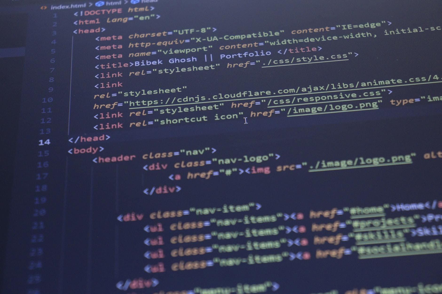 Developer reviewing ecommerce website code on dual monitors