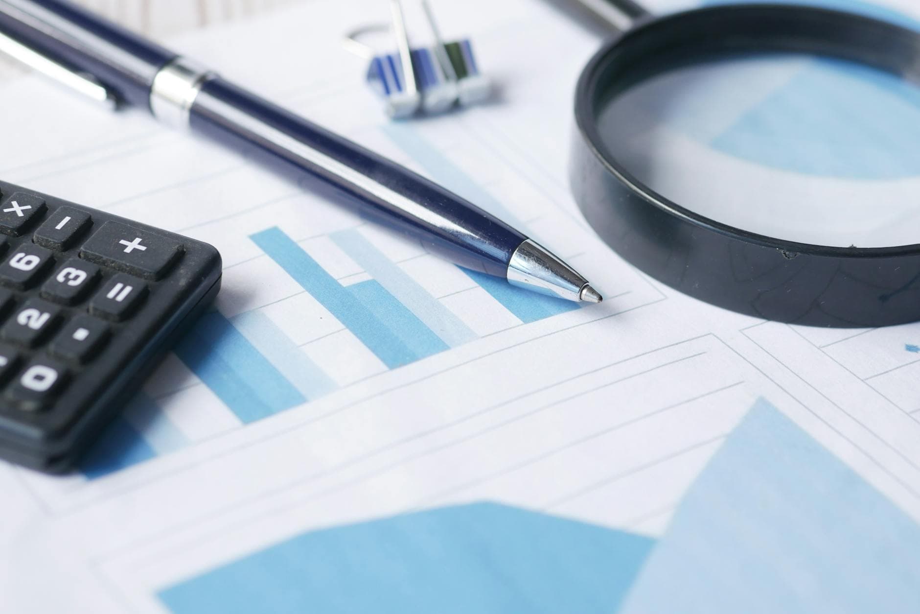 Magnifying glass over website audit report representing SEO audit importance