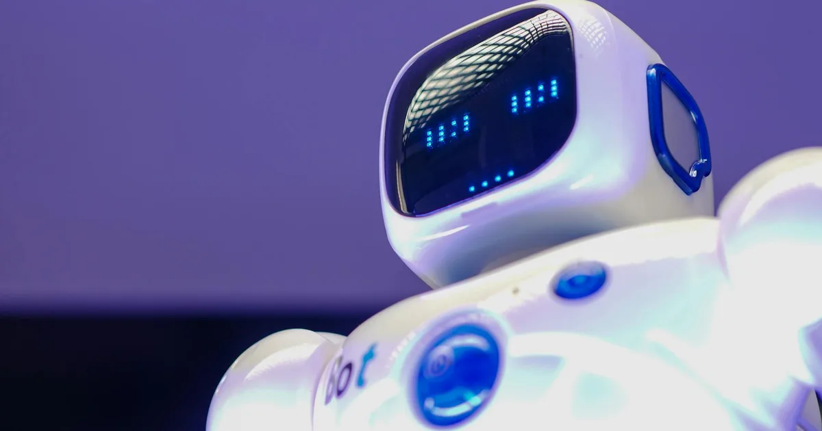 A modern humanoid robot with digital face and luminescent screen, symbolizing innovation in technology.