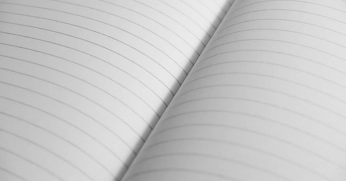 High-resolution close-up of an open notebook with lined pages, perfect for stationery concepts.