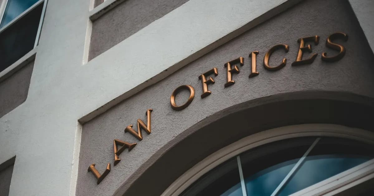 Low angle view of a modern law office exterior with elegant facade and arched entrance.